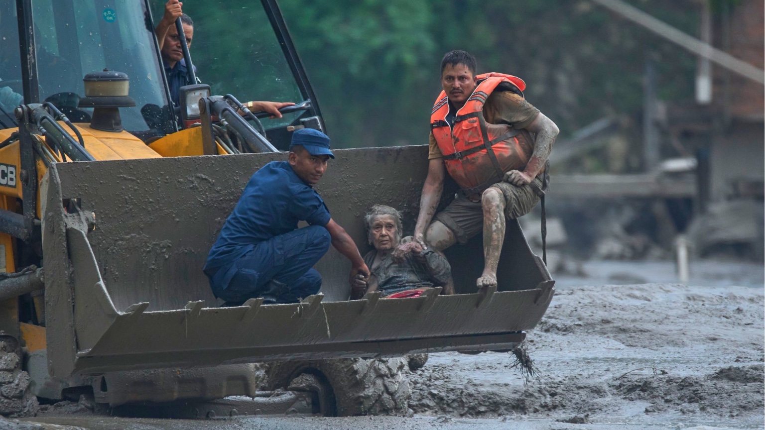 Emergency responders crossing floodwaters in Nepal
